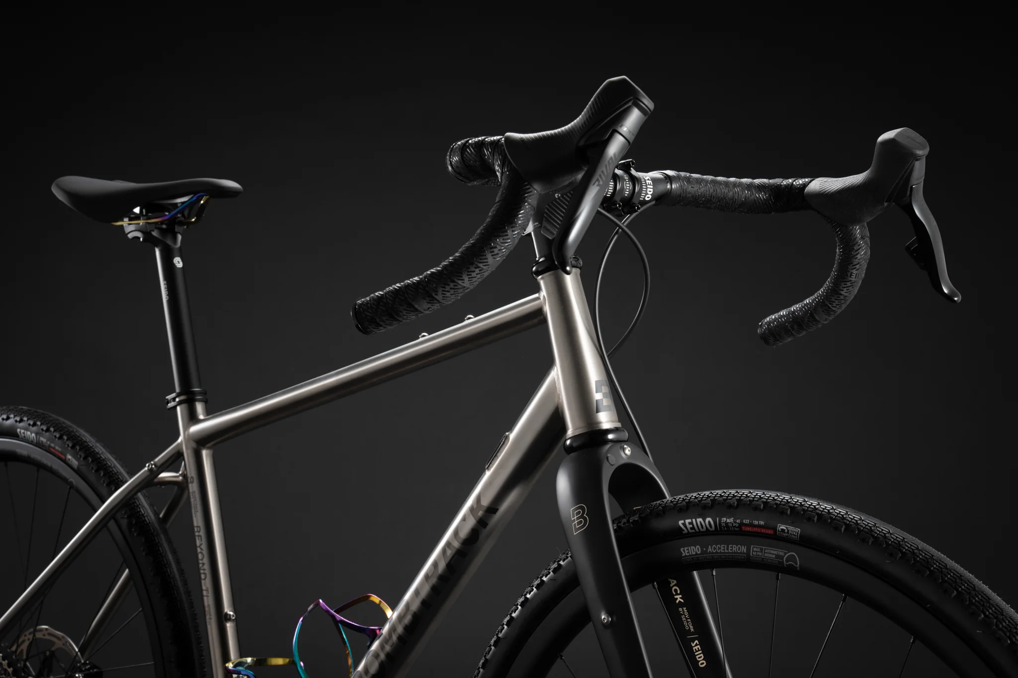 Side-angle shot of a titanium Bombtrack bike frame and Seido carbon fork.