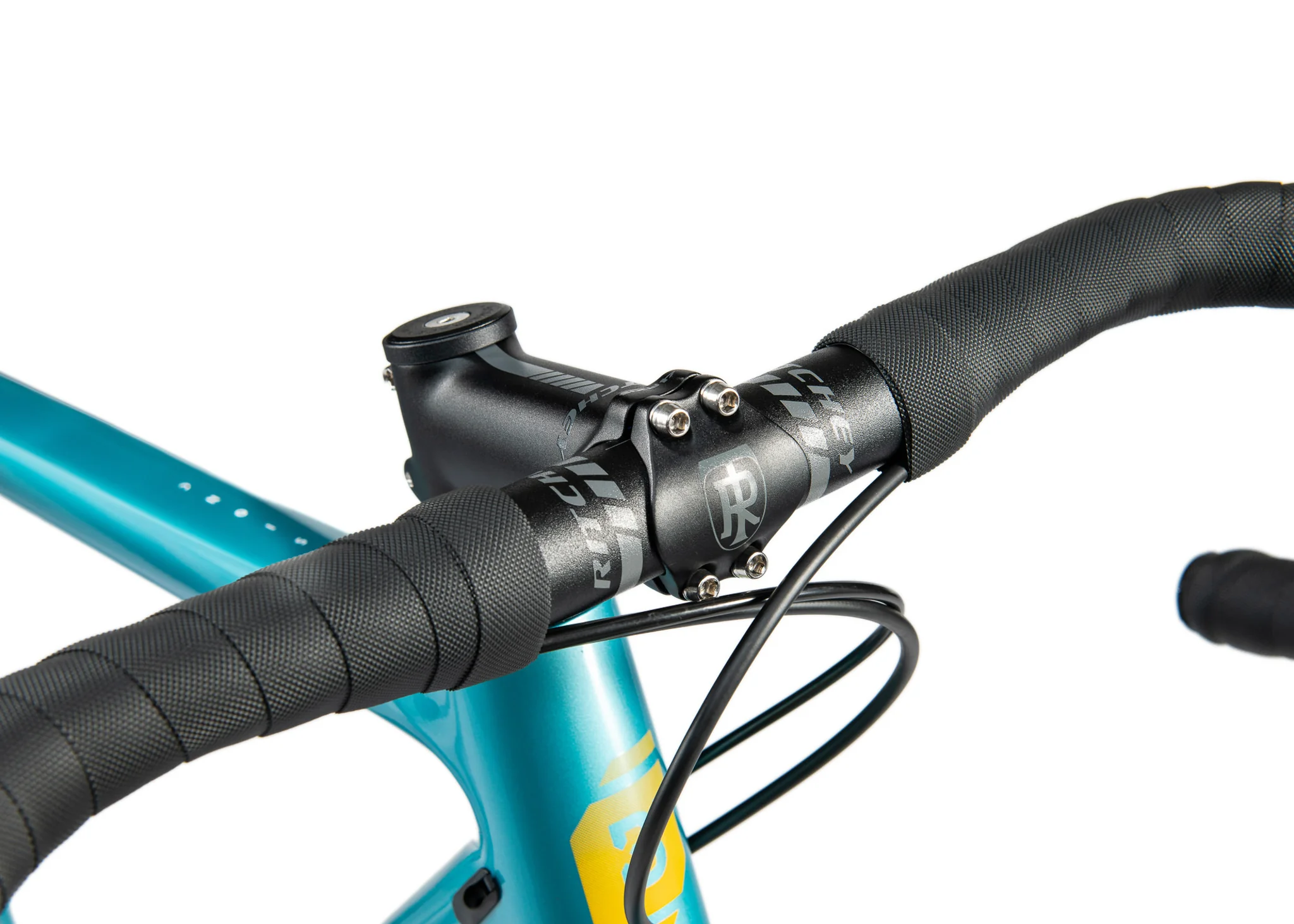 Close-up of a Ritchey stem and handlebars on a teal gravel bike.