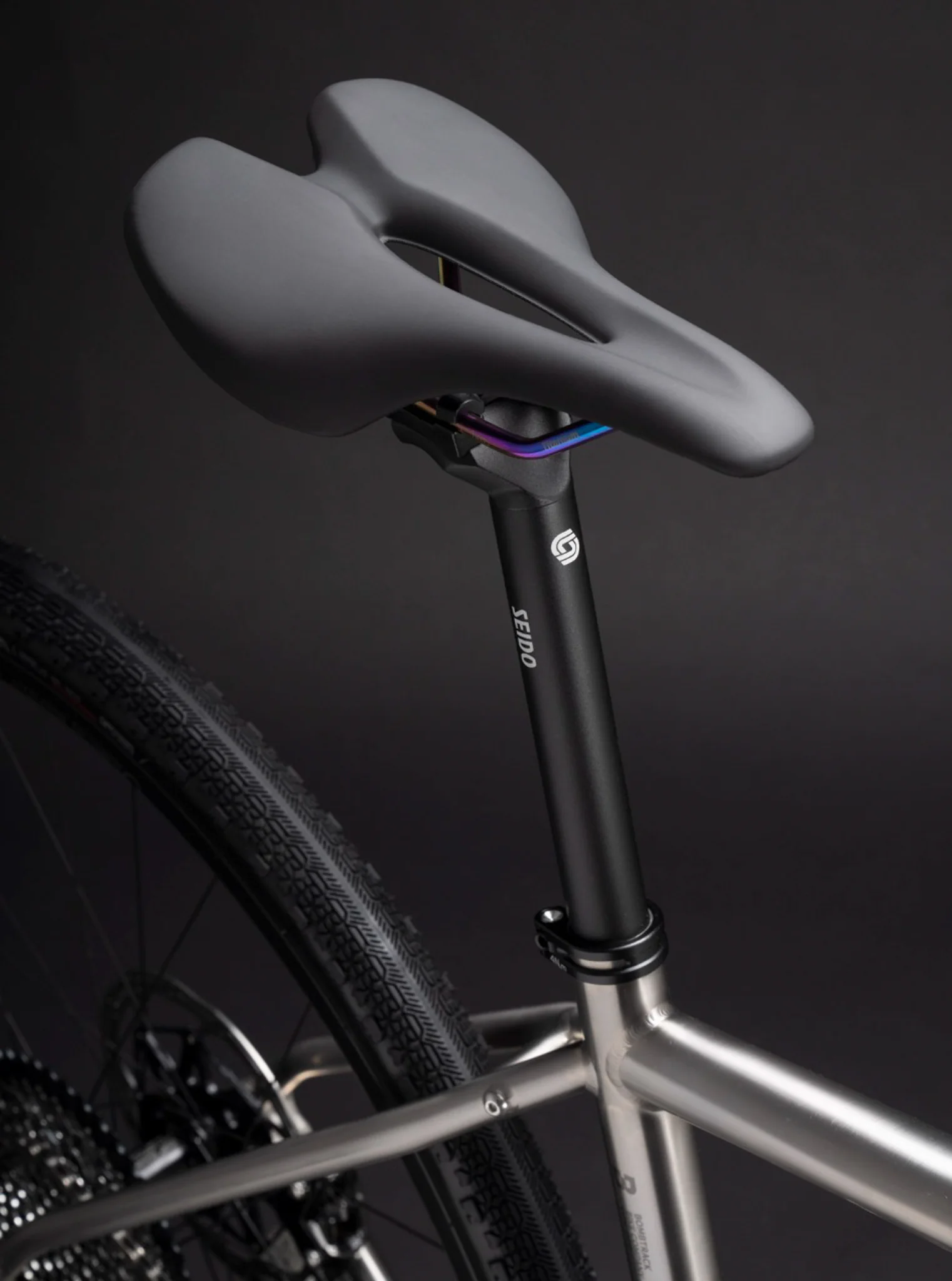 Seido bike saddle and carbon seatpost with oil-slick colored rails.