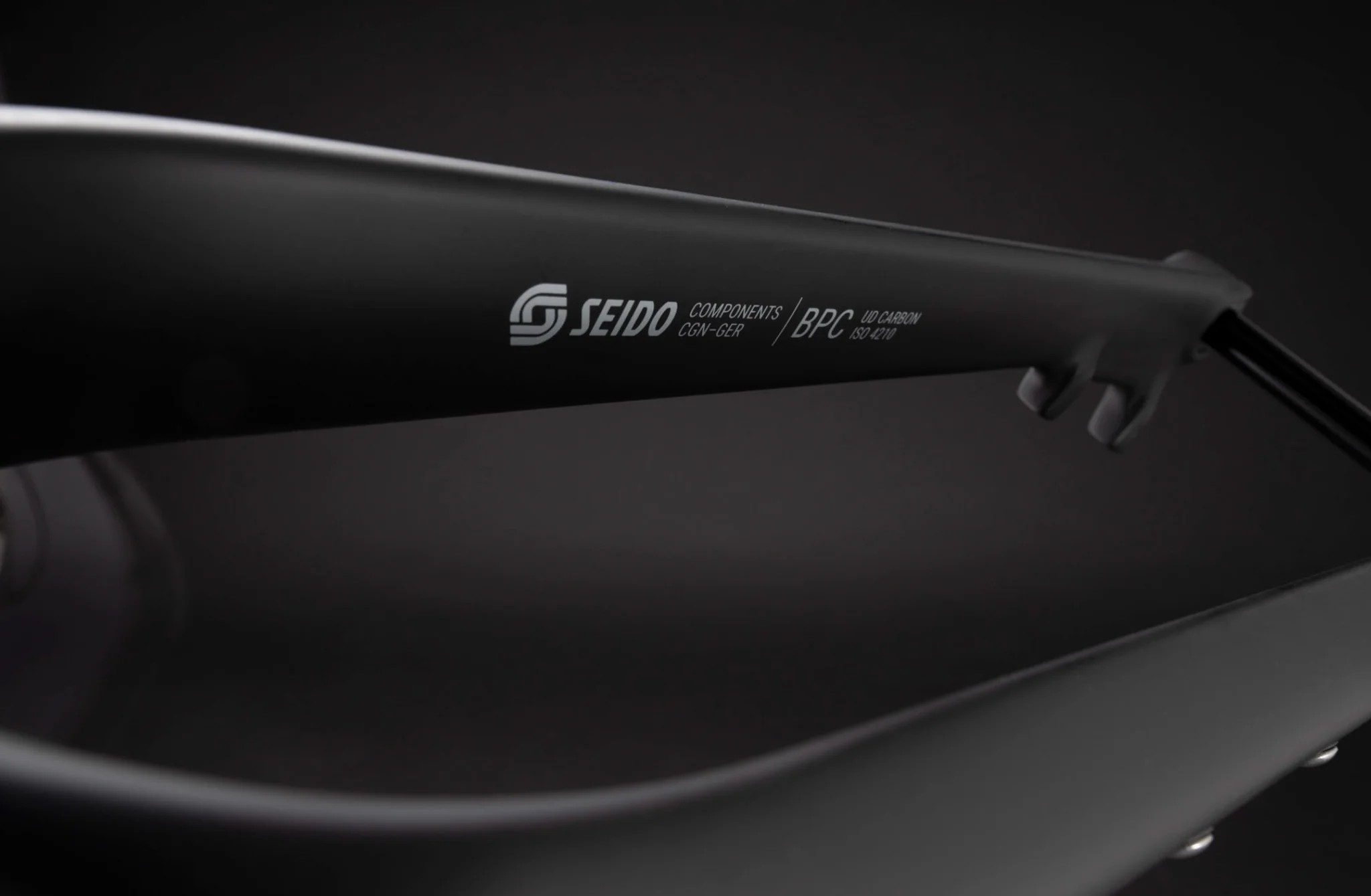 Detail shot of a Seido carbon fork leg with the brand logo in white.
