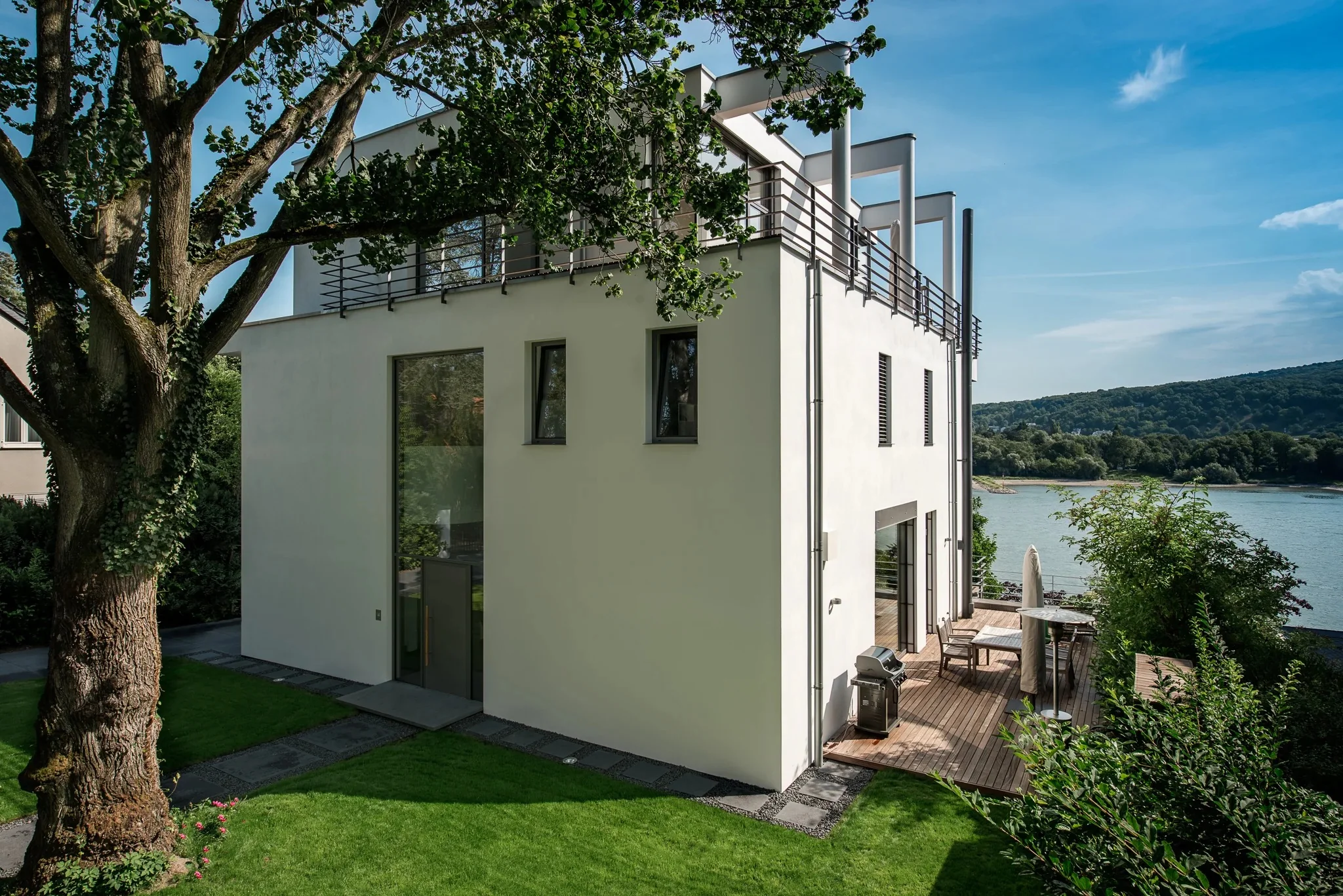 Exterior shot of the minimalist villa and its wooden deck at dusk.