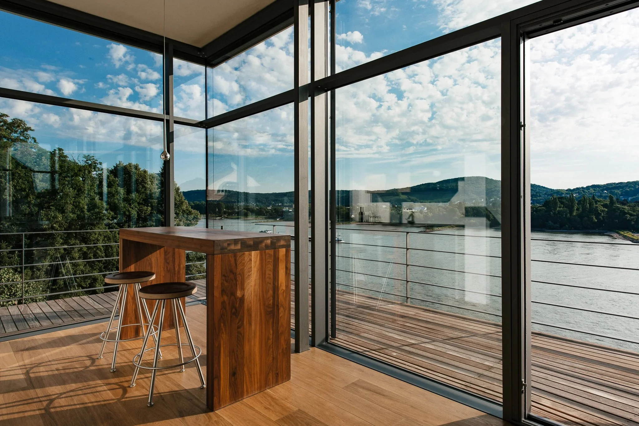 Interior view of the villa overlooking the Rhine through floor-to-ceiling windows.