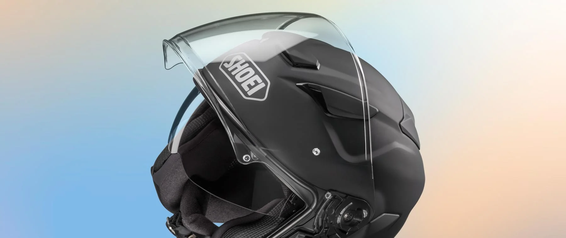 Close-up of the Shoei helmet visor and internal sun shield mechanism.